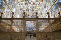 A visitor walks through the Sistine Chapel at the Vatican, Monday, Feb. 1, 2021. The Vatican Museums reopened Monday to visitors after 88 days of shutdown following COVID-19 containment measures. (AP Photo/Andrew Medichini)