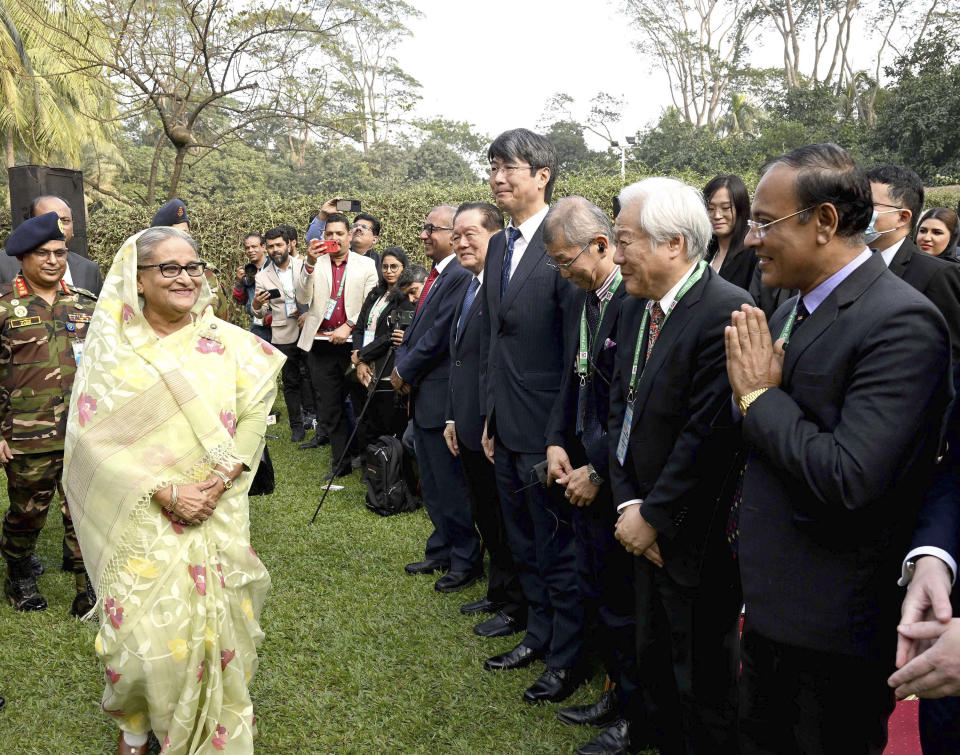 In this photograph released by Bangladesh Prime Minister's office, Prime Minister Sheikh Hasina, left, arrives to address a press conference following her election victory in Dhaka, Bangladesh, Monday, Jan.8, 2024. (Bangladesh Prime Minister's office via AP)