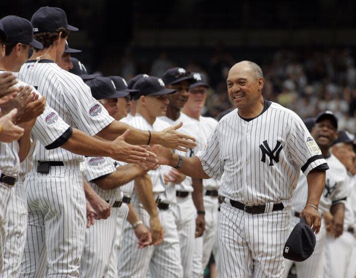 Former Yankees player Reggie Jackson greets other ex-players before an old-timers baseball game at Yankee Stadium