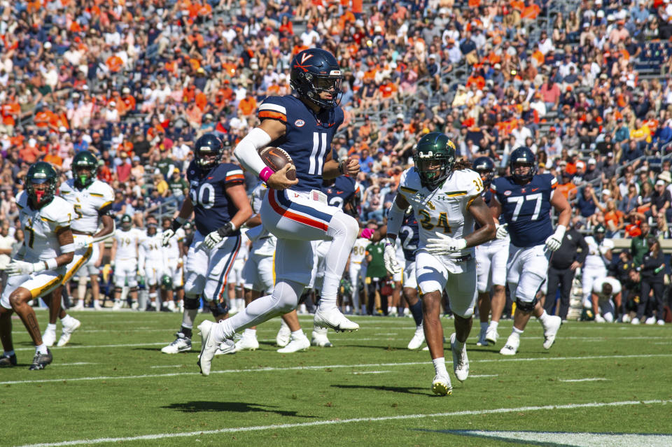 Virginia quarterback Tony Muskett (11) leaps across the goal line for a walk in score against William & Mary during the first half of an NCAA college football game Saturday, Oct. 7, 2023, in Charlottesville, Va. (AP Photo/Mike Caudill)