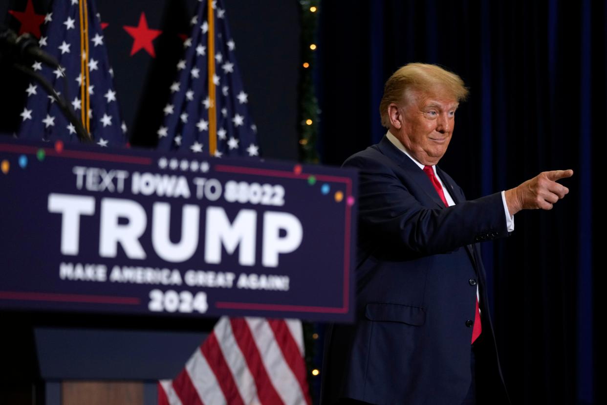 Former President Donald Trump greets supporters as he arrives at a commit to caucus rally, Tuesday, Dec. 19, 2023, in Waterloo, Iowa.