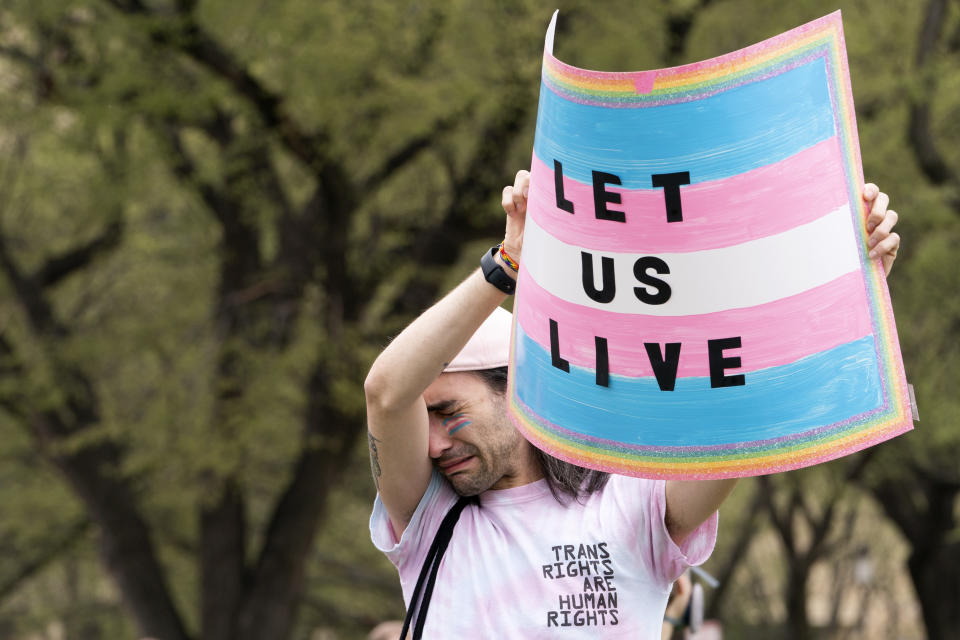 Eli Galvan, 29, of Virginia Beach, Va., reacts while listening to speakers during a rally as part of Transgender Day of Visibility, Friday, March 31, 2023, by the Capitol in Washington. "It's important to stop working against each other and to support each other," says Galvan, "we just want to be able to live, and not to feel that we are in a place where we are broken." (AP Photo/Jacquelyn Martin)