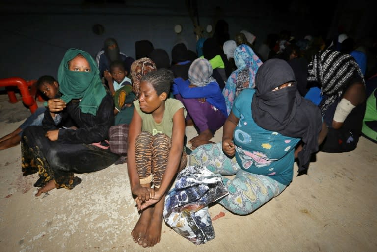 Migrants wait at a naval base in Tripoli, after being rescued in the Mediterranean and returned to Libya by the country's coastguard on June 24