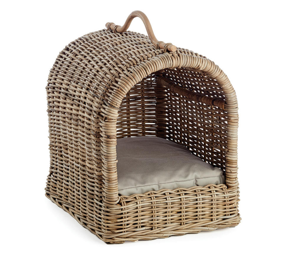 This photo provided by Pottery Barn shows the company's Canopy Pet Bed. No longer are furniture companies content to offer you staples like a sofa, easy chair and bed. Now they have those items for your pet, too, designed not to clash with the rest of your decor. Pottery Barn, Crate and Barrel, Ikea, Casper mattresses and other popular furniture purveyors have lines for pets, often in styles that complement their human-size living room furniture. (Pottery Barn via AP)