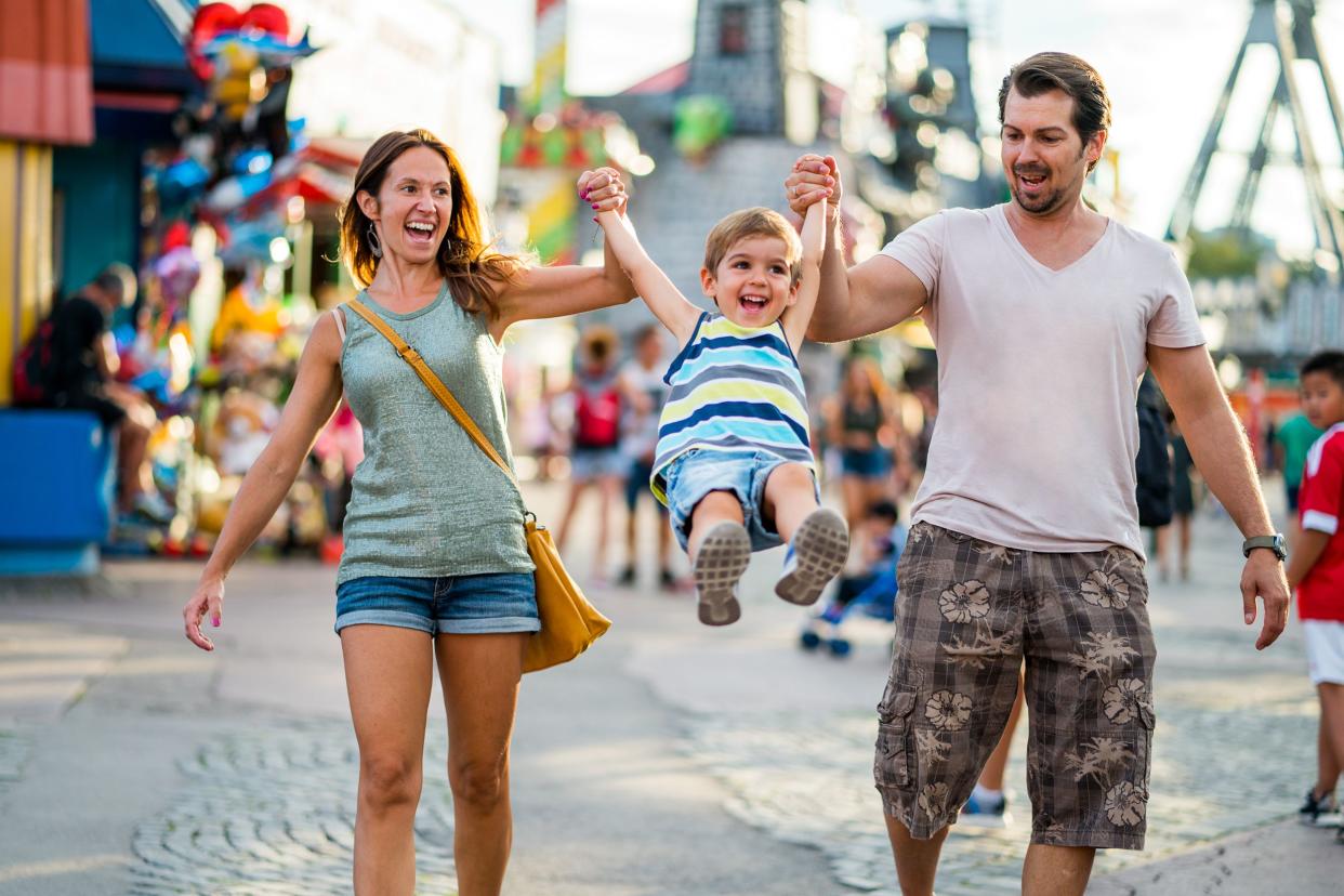 happy family enjoying summer day in amusement park