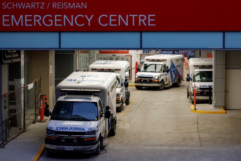 Ambulance paramedics unload patients at the emergency department of Mt. Sinai Hospital, in downtown Toronto, on Jan. 4, 2022. 