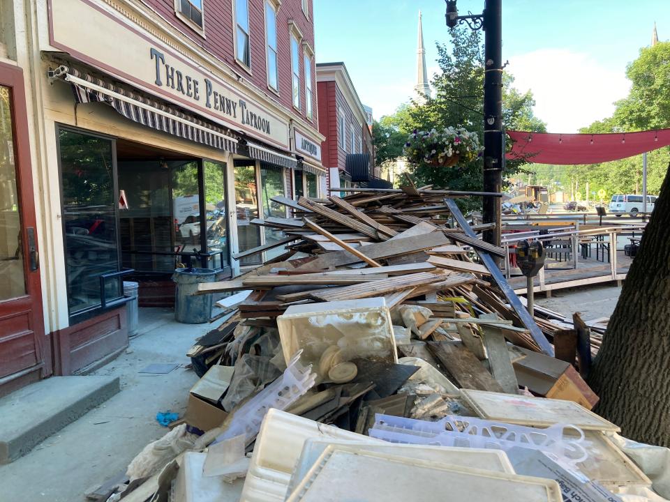 Debris remains on Main Street in front of the Three Penny Taproom on July 20, 2023, more than a week after devastating floods hit Montpelier.