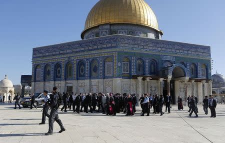 Pope Francis is surrounded by security personnel as the Dome of the Rock is seen in the background during his visit in Jerusalem's Old City