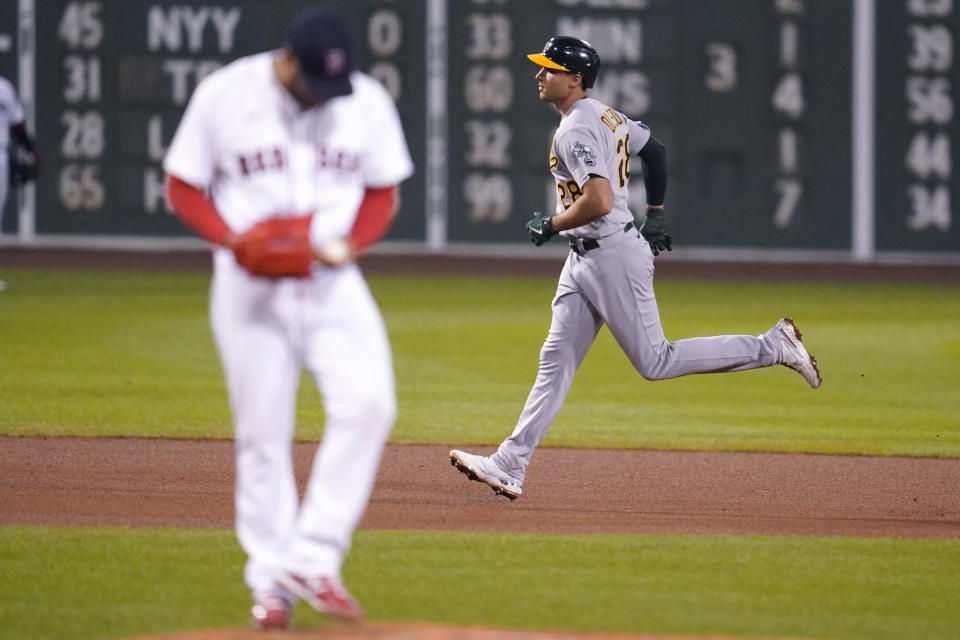 Oakland Athletics' Matt Olson, right, rounds the bases on his solo home run off Boston Red Sox starting pitcher Eduardo Rodriguez during the sixth inning of a baseball game, Wednesday, May 12, 2021, in Boston. (AP Photo/Charles Krupa)