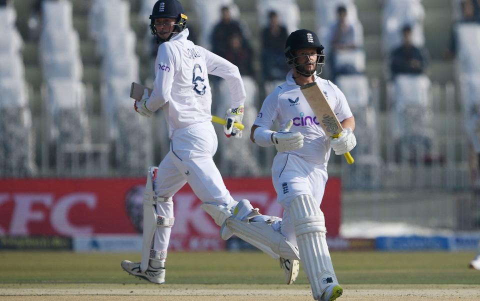 England's Ben Duckett (R) and Zak Crawley run between the wickets during the first day of the first cricket Test match between Pakistan and England at the Rawalpindi Cricket Stadium, i - Amir Qureshi/Getty Images