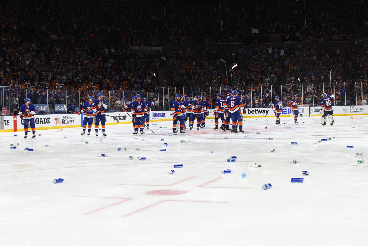 Billy Smith cracks open a beer on the ice right after the Islanders swept  the Oilers