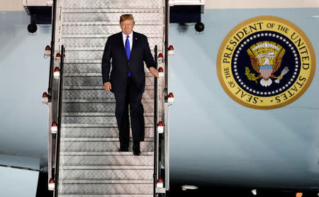 U.S. President Donald Trump steps off his plane as he arrives at Paya Lebar Air Base in Singapore, ahead of a summit with North Korean leader Kim Jong Un, June 10, 2018. REUTERS/Kim Kyung-Hoon