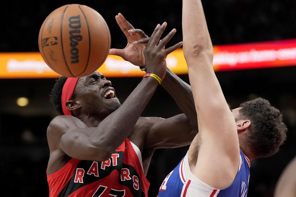 Toronto Raptors forward Pascal Siakam. left, loses the ball as he collides with Philadelphia 76ers forward Georges Niang during the first half of an NBA basketball game Thursday, April 7, 2022, in Toronto. (Frank Gunn/The Canadian Press via AP)