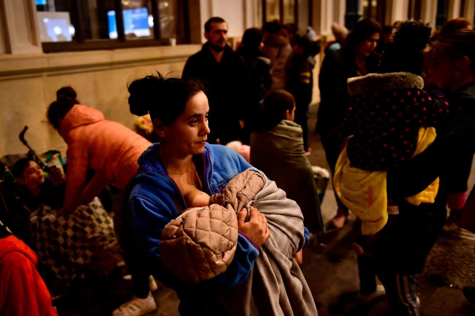 A mother fleeing from Ukraine breastfeeds her son at Nyugati station, after Russia launched a massive military operation against Ukraine, in Budapest, Hungary, February 27, 2022. REUTERS/Marton Monus REFILE - CORRECTING TRAIN STATION