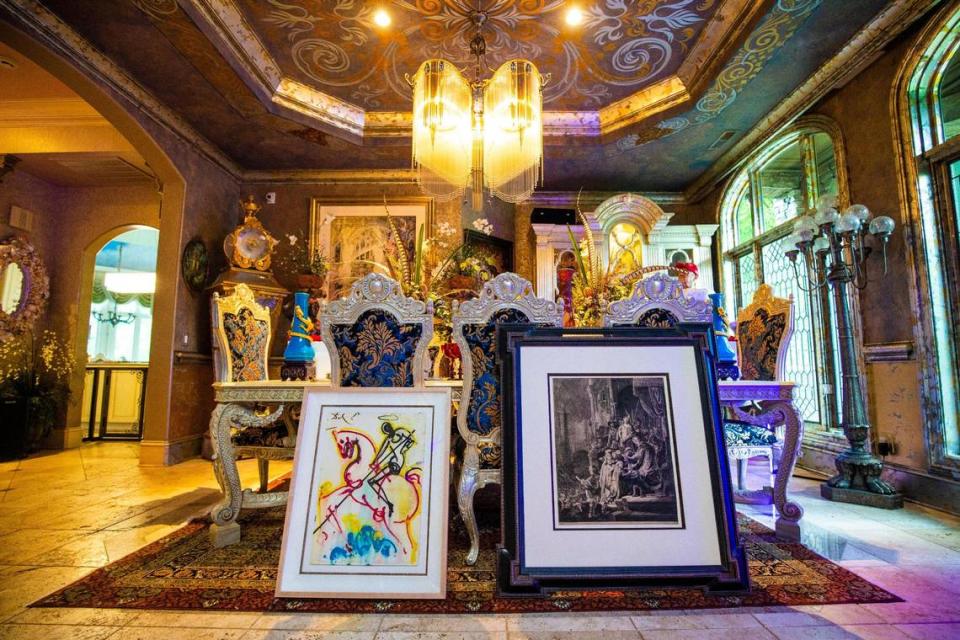 Dr. Christopher Heath Brown enjoys collecting pieces with a religious theme like Rembrandt’s etching “Christ Before Pilate,” front right. At front left is a 1972 Salvador Dalí lithograph called “St. George” from the Dalinean Horses Suite.