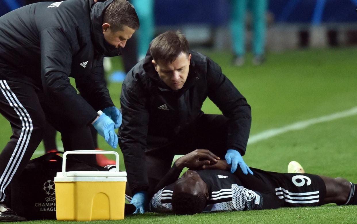 Sheriff's Malian forward Adama Traore receives medical attention after going down clutching his chest against Real Madrid - AFP