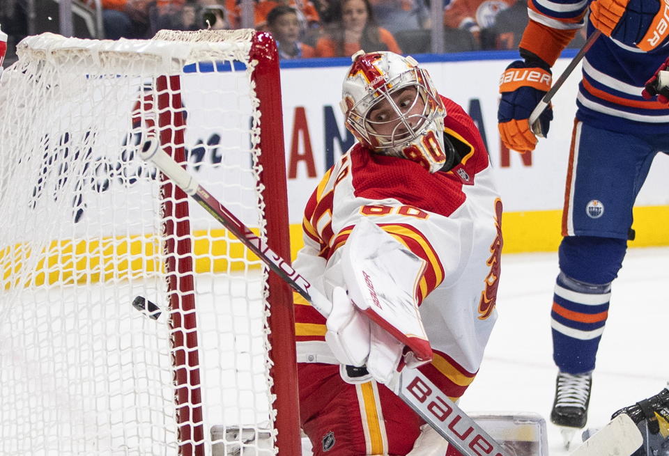 Calgary Flames goalie Dan Vladar gives up a goal to the Edmonton Oilers during the second period of an NHL hockey game Saturday, Oct. 15, 2022, in Edmonton, Alberta. (Jason Franson/The Canadian Press via AP)