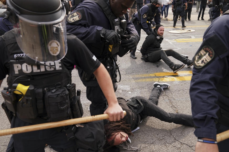 Police detain protesters, Wednesday, Sept. 23, 2020, in Louisville, Ky. A grand jury has indicted one officer on criminal charges six months after Breonna Taylor was fatally shot by police in Kentucky. The jury presented its decision against fired officer Brett Hankison Wednesday to a judge in Louisville, where the shooting took place. (AP Photo/John Minchillo)