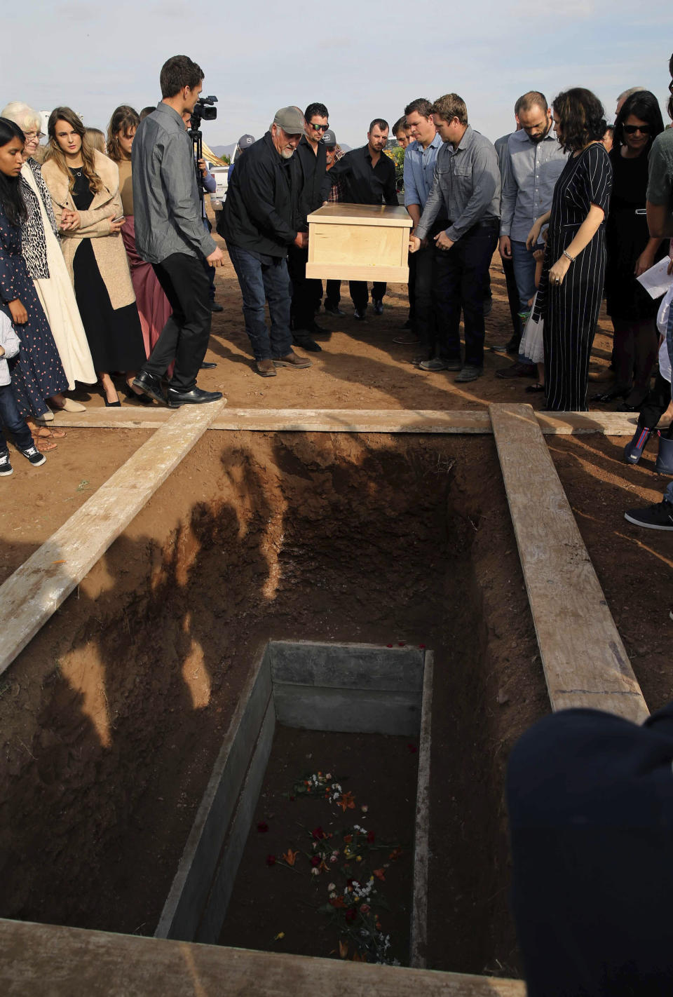 Pall bearers carry the coffin that contain the remains of Christina Langford Johnson the last victim of a cartel ambush that killed nine American women and children earlier this week, to a burial site in Colonia LeBaron, Mexico, Saturday, Nov. 9, 2019. In the attack Monday, Langford Johnson jumped out of her vehicle and waved her hands to show she was no threat to the attackers and was shot twice in the heart, community members say. Her daughter Faith Marie Johnson, 7 months old, was found unharmed in her car seat. (AP Photo/Marco Ugarte)