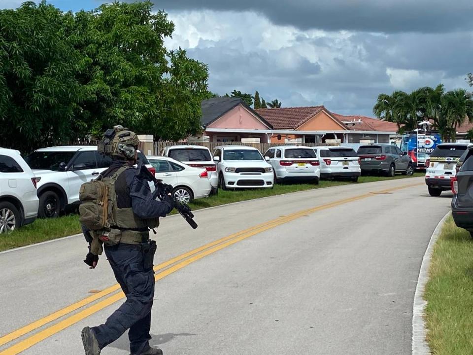A member of Miami-Dade Police Department’s Special Response Team walks down Southwest 172nd Street holding a semiautomatic rife Friday, Oct. 27, 2023.