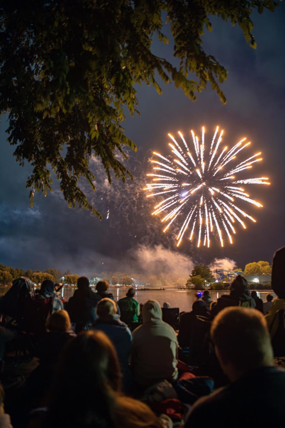 Fort Collins residents surround Sheldon Lake at City Park to watch the annual Independence Day fireworks display on Tuesday, July 4, 2023. The display was delayed multiple times due to severe weather before the first firework flew into the sky.