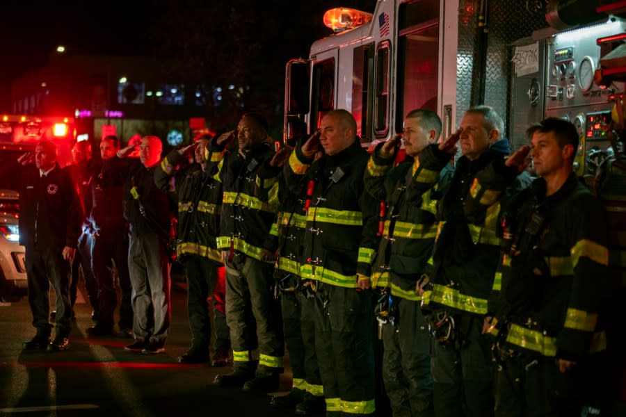Firefighters salute as the ambulance transporting the body of New York City Police Officer Jonathan Diller exits Jamaica Hospital Medical Center in the Queens borough of New York, Monday, March 25, 2024. Diller was shot and killed Monday during a traffic stop. It marked the first slaying of an NYPD officer in two years. (AP Photo/Jeenah Moon)