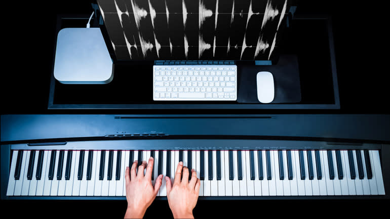 Overhead image of fingers on a piano