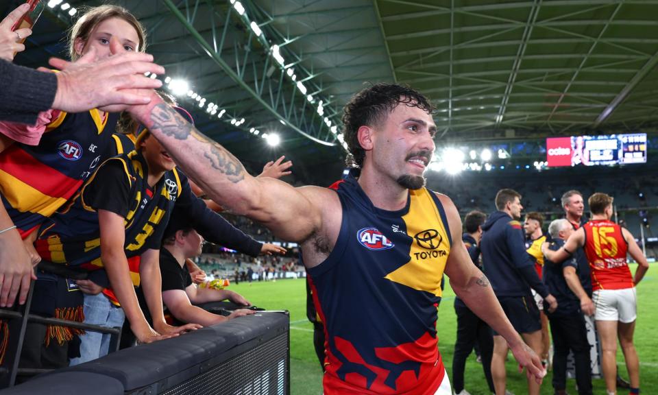 <span>Adelaide star Izak Rankine high fives Crows fans after the Rd 5 victory over Carlton at Marvel Stadium.</span><span>Photograph: Quinn Rooney/Getty Images</span>