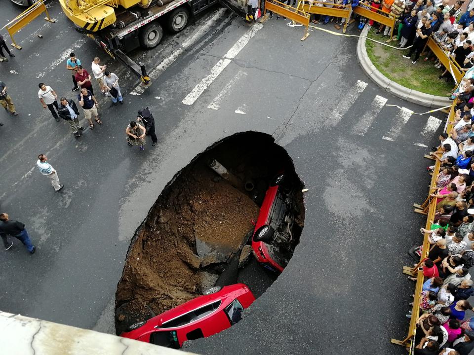 Two cars stuck in a sinkhole in northeast China.