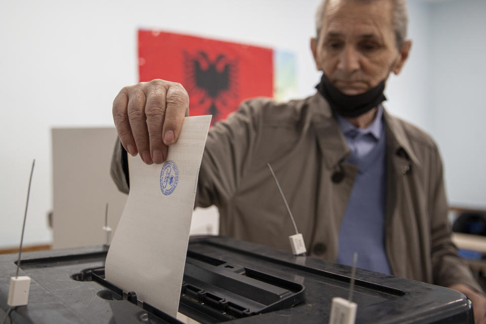 An Albanian man casts his vote during parliamentary elections in capital Tirana, Albania on Sunday, April 25, 2021. Albanian voters have started casting ballots in parliamentary elections on Sunday amid the virus pandemic and a bitter political rivalry between the country's two largest political parties. (AP Photo/Visar Kryeziu)