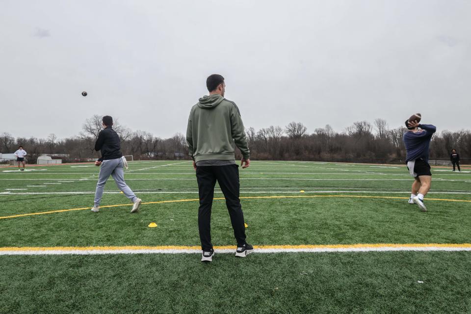 Former Smyrna High and University of Delaware Quarterback Nolan Henderson (center) looks on during a quarterbacks training session on Sunday, February 11, 2024 at Red Lion Christian Academy turf field in Bear.