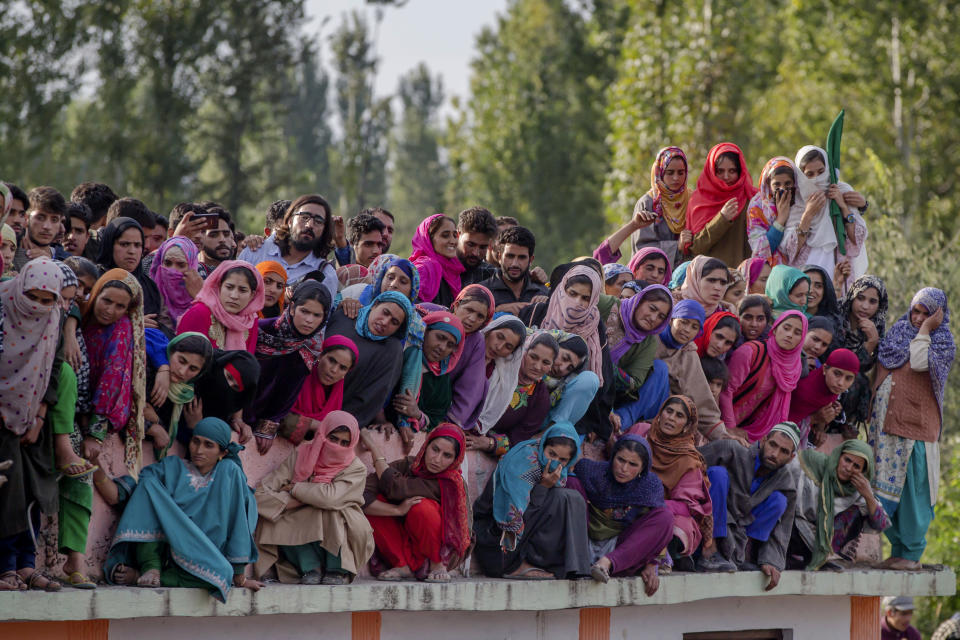 Kashmiri villagers watch the funeral procession of top rebel commander Gulzar Ahmed Paddroo during his funeral procession in Aridgeen, about 75 kilometers south of Srinagar, Indian controlled Kashmir, Saturday, Sept 15, 2018. Indian troops laid a siege around a southern village in Qazigund area overnight on a tip that militants were hiding there, police said. A fierce gunbattle erupted early Saturday, and hours later, five local Kashmiri rebels were killed. (AP Photo/Dar Yasin)