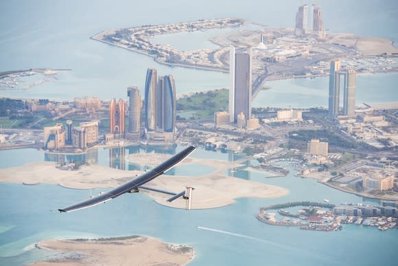 Solar plane flying over a city.