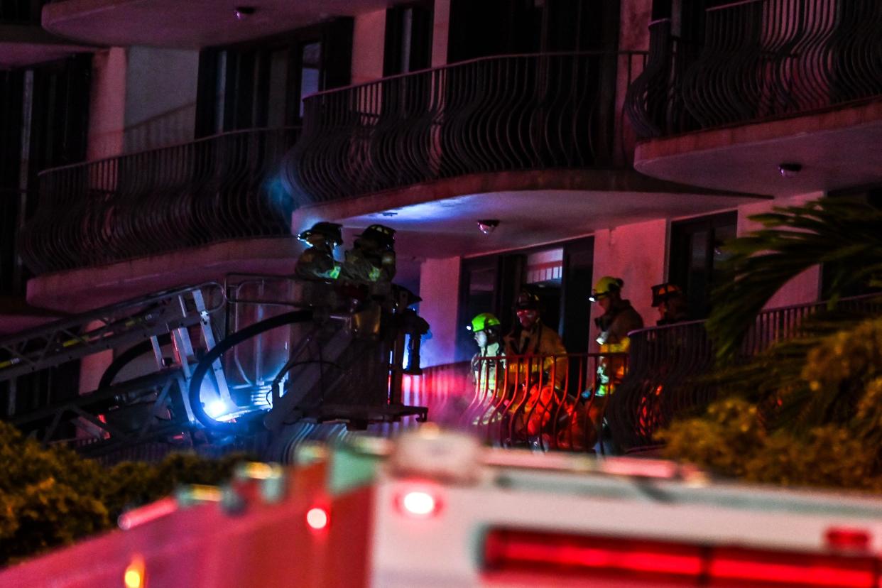 First Responders rescue a resident from a partially collapsed residential building in Miami Beach, Florida, early June 24, 2021.