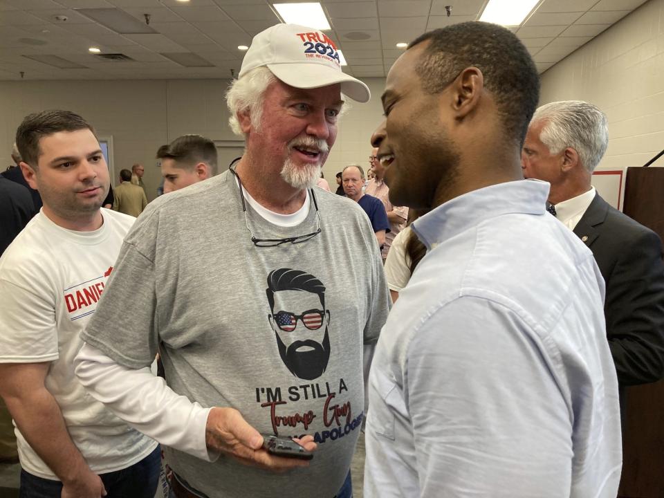 Republican gubernatorial candidate Daniel Cameron, right, speaks with voters after a campaign rally in Louisville, Ky., Wednesday, April 12, 2023. Cameron reaffirmed his support for gun rights in the aftermath of the mass shooting in Louisville. (AP Photo/Bruce Schreiner)