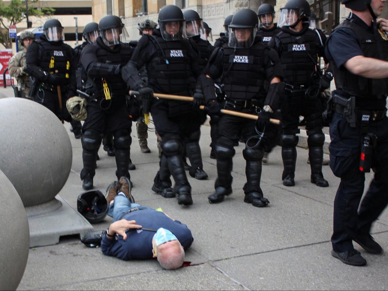 <p>Martin Gugino, a 75-year-old protester, lays on the ground after he was shoved by two Buffalo, New York, police officers during a protest against the death in Minneapolis police custody of George Floyd in Niagara Square in Buffalo, New York, on 4 June 2020</p> ((Mike Desmond - WBFO))