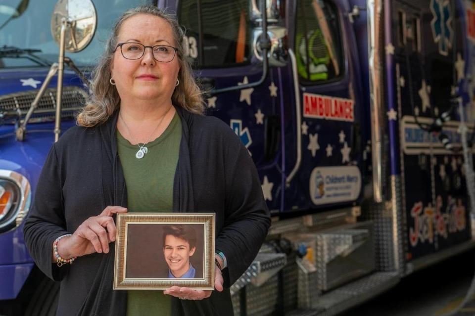 Heather Scruton, assistant director of the Critical Care Transport team at Children’s Mercy, holds a photo of her son, Adam, who died by suicide two years at the age of 21. Scruton said as a mother who has been touched by the nation’s mental health crisis, the hospital’s $275 million plan to battle the pediatric emergency gives her hope.