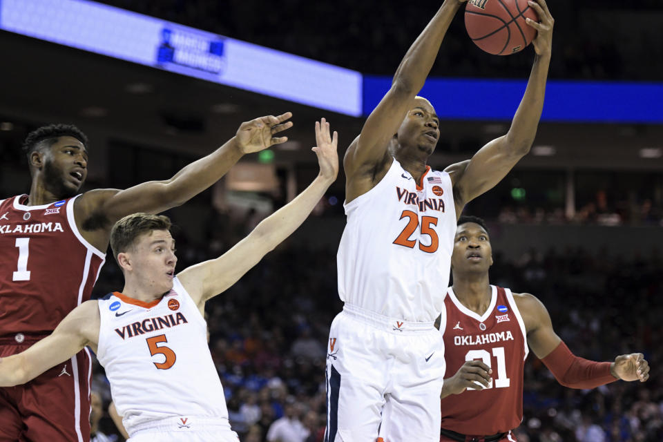 Virginia's Mamadi Diakite (25) and Kyle Guy (5) compete for a rebound against Oklahoma's Rashard Odomes (1) and Kristian Doolittle (21) during the first half of a second-round game in the NCAA men's college basketball tournament Sunday, March 24, 2019, in Columbia, S.C. (AP Photo/Sean Rayford)