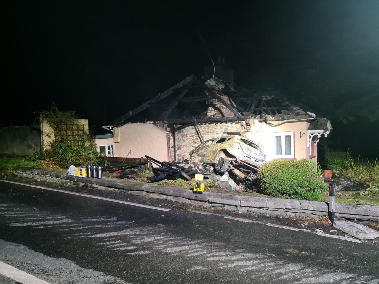 A photograph shows the extent of damaged caused by a car colliding with a property in Cornwall on 18 October, 2020.  (Twitter/Fowey Community Fire Station )