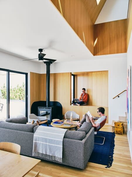 The couple hired architect Matthew Hufft to design a simple house where they could spend time with friends and family, and rent out to vacationers. The interior of the three-bedroom, two-bathroom home is white with birch plywood, the latter material influenced by Jon's work with Scandinavian cabins at Getaway.