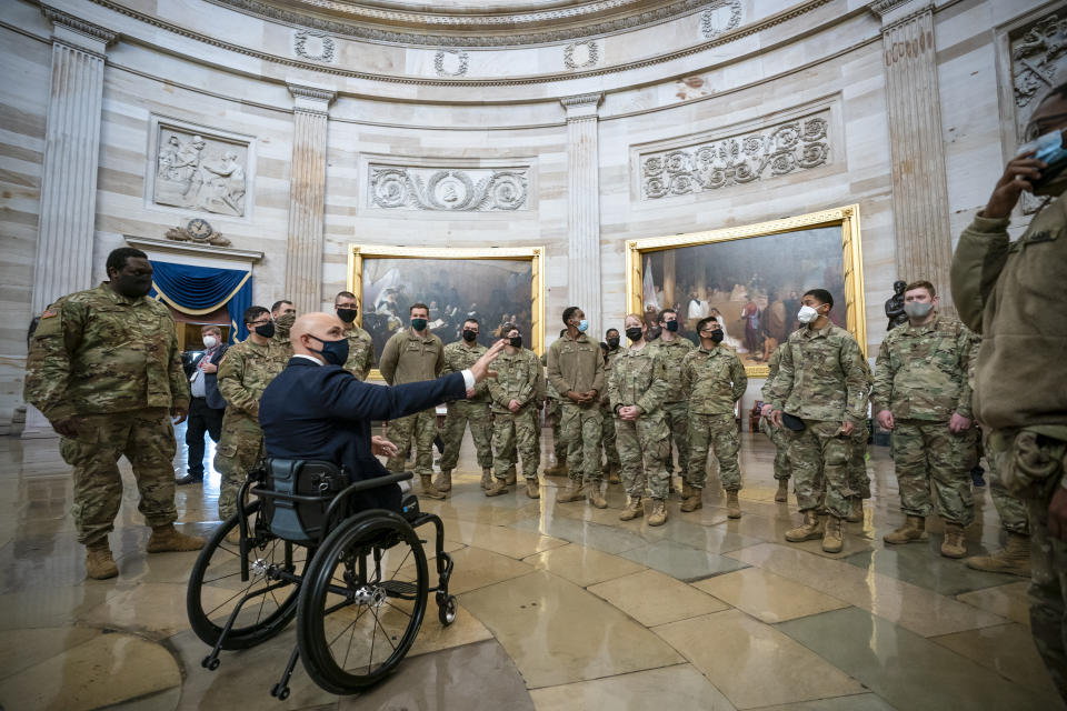 Rep. Brian Mast, R-Fla., left, visits with National Guard troops who are helping with security at the Capitol Rotunda in Washington, Wednesday, Jan. 13, 2021. (AP Photo/J. Scott Applewhite)