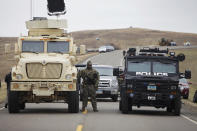 <p>A North Dakota law enforcement officers stands next to two armored vehicles just beyond the police barricade on Highway 1806 near a Dakota Access Pipeline construction site near the town of Cannon Ball, N.D., on Oct. 30, 2016. (Josh Morgan/Reuters) </p>