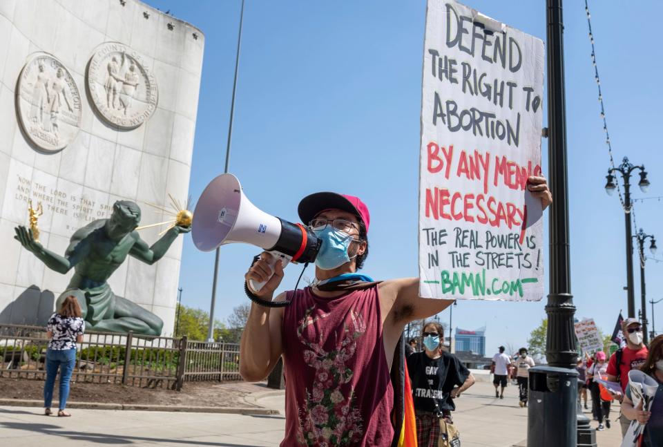 Justin Cheong of BAMN walks past the Coleman A. Young Municipal Center during a protest to protect abortion rights and the continuation of abortion medication in Detroit on Saturday, April 15, 2023. 