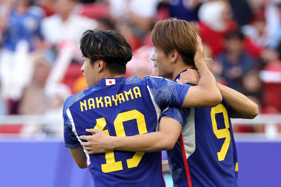 Nakayama congratulates goalscorer Ueda for netting the penalty (Getty Images)