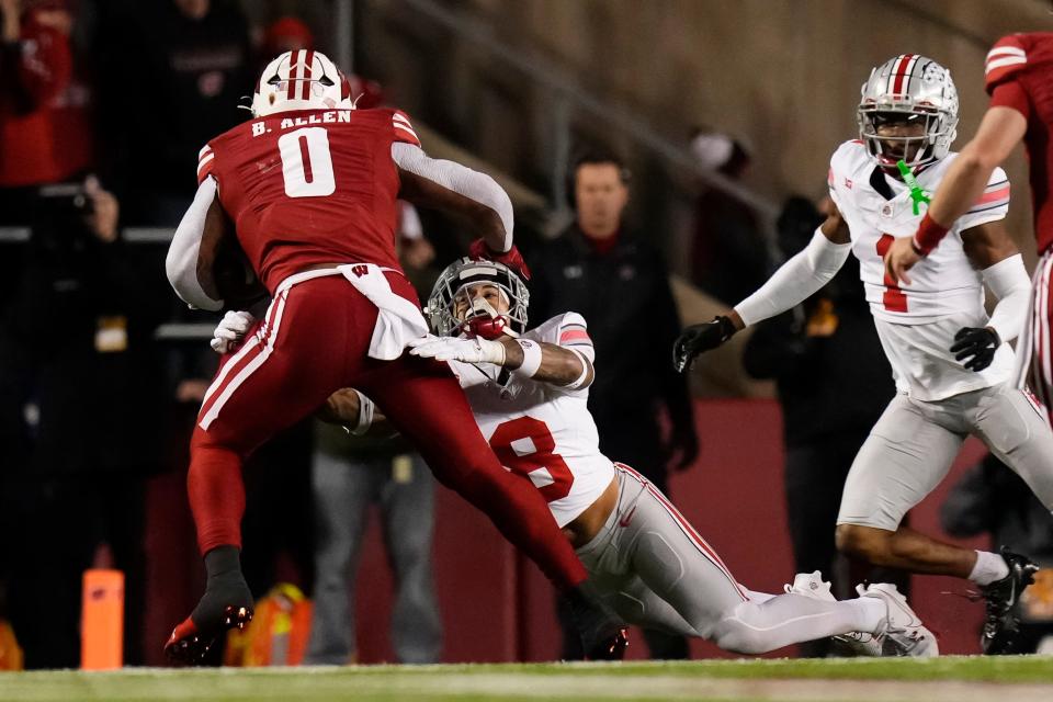 Oct 28, 2023; Madison, Wisconsin, USA; Ohio State Buckeyes safety Lathan Ransom (8) hits Wisconsin Badgers running back Braelon Allen (0) during the first half of the NCAA football game at Camp Randall Stadium.