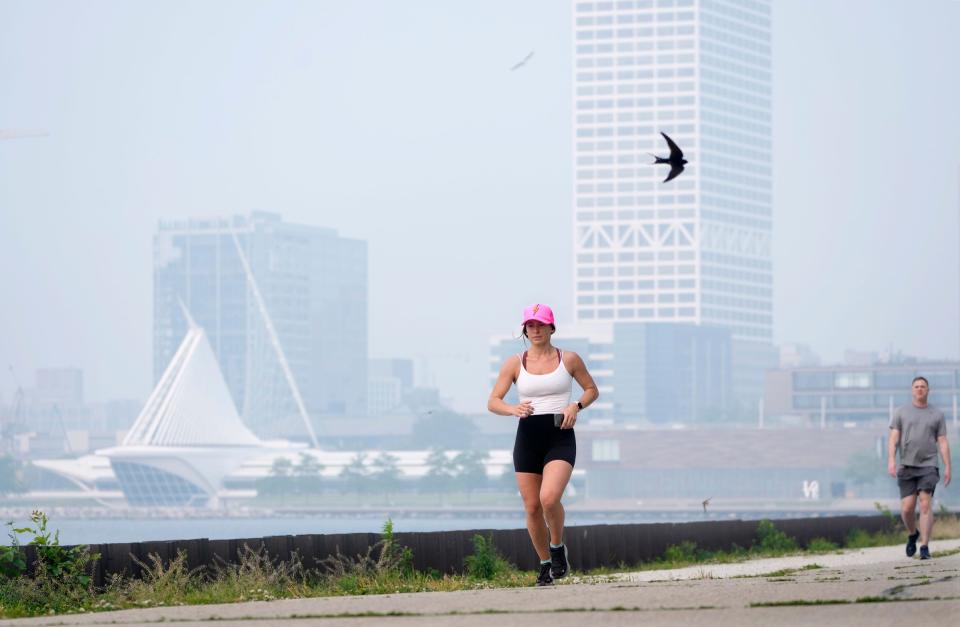 A haze of smoke hovers in the air as Alli Maddelein, of Milwaukee, takes a 5 mile jog through Veteran’s Park in Milwaukee on Tuesday. The quality of Wisconsin's air was among the worst in the world again on Tuesday, worse even than it was on Monday as smoke from Canadian fires continues to sit over the city.