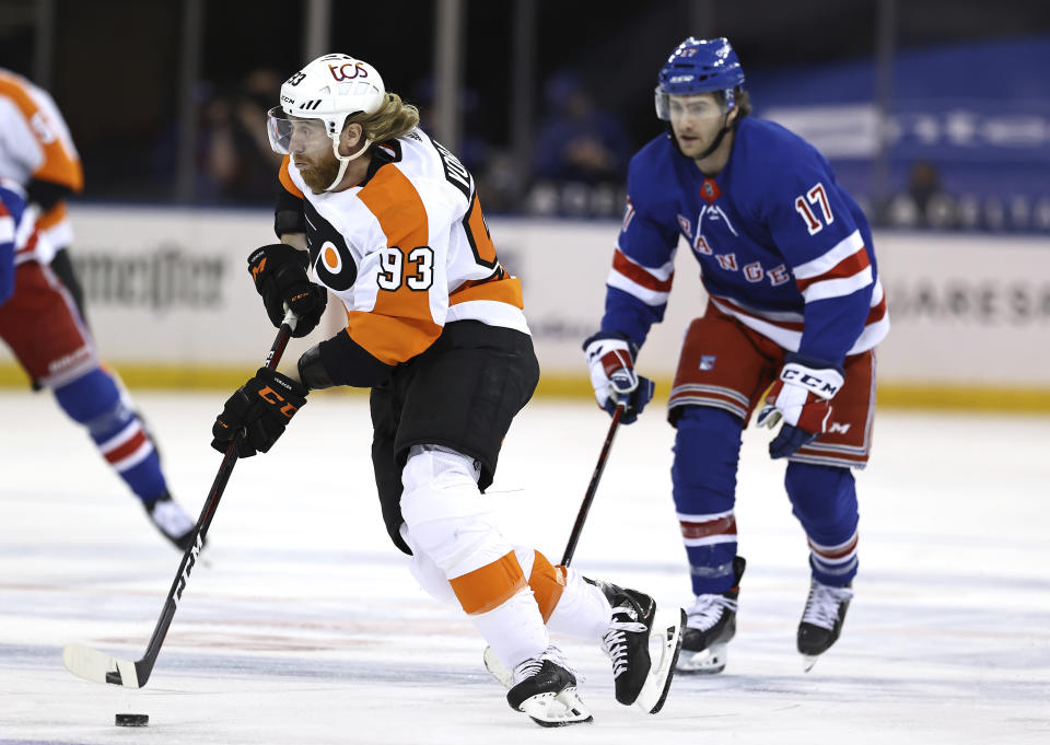 Philadelphia Flyers' Jakub Voracek (93) takes the puck as New York Rangers' Kevin Rooney (17) defends in the first period of an NHL hockey game Thursday, April 22, 2021, in New York. (Elsa/Pool Photo via AP)