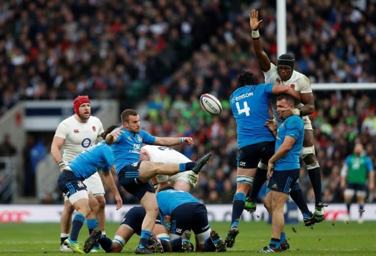 Italy's Giorgio Bronzini kicks the ball up-field as England's flanker Maro Itoje (R) tries to block during the Six Nations international rugby union match between England and Italy at Twickenham stadium in southwest London on February 26, 2017