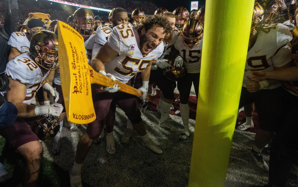 Minnesota linebacker Mariano Sori-Marin (55) wields the Paul Bunyan Axe after their game Saturday, November 26, 2022 at Camp Randall Stadium in Madison, Wis. Minnesota beat Wisconsin 23-16.