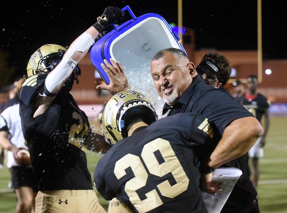 Lubbock High's football team pours water on head coach Juan Rodriguez after a win over Levelland on Thursday, Sept. 8, 2022, at Lowrey Field at PlainsCaptial Park. Lubbock High won, 21-14.